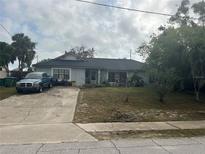 Modest single story home with a lawn and a blue truck in the driveway at 1400 Hayward Ave, Deltona, FL 32738