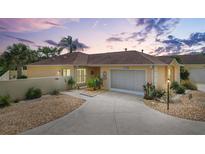 Charming single-story home with a well-manicured lawn, palm trees, and an attached two-car garage in a desirable neighborhood at 1139 Santa Cruz Dr, The Villages, FL 32162