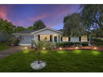 Charming single-story home with a well-manicured lawn and screened garage at 11540 Sw 84Th Avenue Rd, Ocala, FL 34481