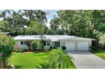 Charming single-story home with a well-manicured lawn, mature trees and a two-car garage at 3610 Pershing Ave, Orlando, FL 32812