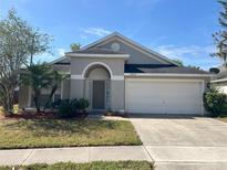 Charming single-story home featuring a well-maintained lawn, mature landscaping, and an attached two-car garage at 10930 Buckwater Ct, Orlando, FL 32817