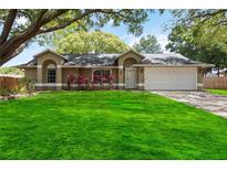 Charming single-story home with a lush green lawn and vibrant red landscaping creating curb appeal at 5003 Timber Ridge Trl, Ocoee, FL 34761