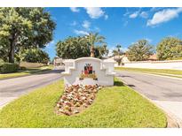 Elegant Vizcaya community entrance sign with lush landscaping and a clear blue sky backdrop at 8749 The Esplanade # 6, Orlando, FL 32836
