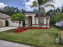 Charming single-story home featuring a well-manicured lawn and mature landscaping at 15824 Green Cove Blvd, Clermont, FL 34714