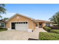Charming single-story home boasts a paved driveway, attached garage, and manicured landscaping at 8166 Sw 80Th Ter, Ocala, FL 34476