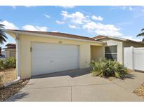 Charming single-story home with a two-car garage and well-maintained landscaping at 1787 Foliage Ln, The Villages, FL 32162