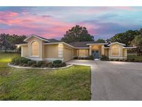 Charming single-story home featuring a well-maintained lawn and a private driveway at 2899 Sw 66 St, Ocala, FL 34476