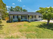 Charming single-story home featuring a well-maintained lawn and inviting front porch at 219 Vermont Ave, St Cloud, FL 34769