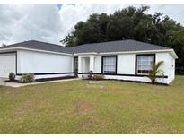 Charming one-story home with a well-maintained lawn, fresh exterior paint and an inviting entrance at 5356 Spivey Glen Ct, Lakeland, FL 33810