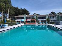 Inviting community pool with lounge chairs offers a relaxing outdoor experience at 535 Midway Dr # A, Ocala, FL 34472