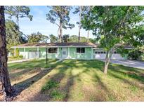 Charming single story home featuring a well-maintained lawn and a two car garage at 641 Jackson St, Eustis, FL 32726