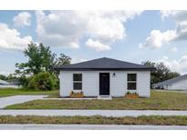 Charming single-story home featuring a freshly painted exterior, a modern roof and landscaped front yard at 991 Polk St, Bartow, FL 33830