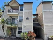 Inviting condo building with a charming balcony, and landscaped entry at 1948 Lake Atriums Cir # 132, Orlando, FL 32839