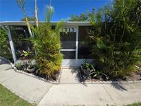 Charming entrance to the home with vibrant greenery and clearly marked address number at 4213 E Michigan St # 4213, Orlando, FL 32812