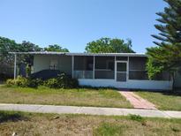 Modest home featuring a front porch with a brick pathway leading to the entrance at 6971 Pompeii Rd, Orlando, FL 32822