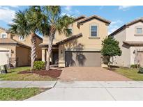 Charming two-story home with a well-manicured lawn and a two-car garage is perfect for families at 5545 Misty Oak Cir, Davenport, FL 33837