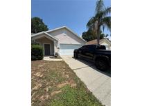 Charming single-story home features an attached garage, front yard, and a driveway with parking at 294 Lake Doe Blvd, Apopka, FL 32703