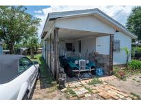Carport view of a house and classic car at 7043 Curtis Ave, Groveland, FL 34736