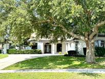 Charming single-story home featuring manicured landscaping and a lush lawn at 11315 Cypress Shore Ct, Clermont, FL 34711