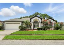 Charming single-story home with a well-manicured lawn and a two-car garage at 3909 Corveta Ct, Orlando, FL 32837