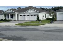 Charming single-story home featuring a three-car garage, manicured lawn and meticulous landscaping at 742 Copper Creek Dr, New Smyrna Beach, FL 32168