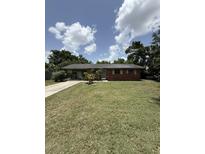 Charming single-story brick home with a well-maintained lawn, ready for your personal touch at 1516 Avenue D Ne, Winter Haven, FL 33881