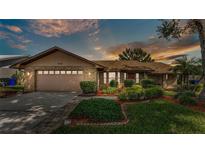 Charming single Gathering home with a well-manicured lawn, beautiful landscaping, and a two car garage at 4120 Chelsea Ln, Lakeland, FL 33809