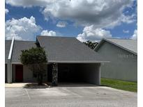 Home exterior featuring an attached carport with stone accents and a well-maintained roof at 888 W Stuart St, Bartow, FL 33830