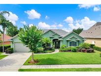 Charming single-story home with lush landscaping and a well-manicured lawn at 17426 Tailfeather Ct, Clermont, FL 34711