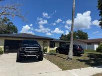 A single Gathering home with a driveway and lawn, under a blue sky with cumulus clouds at 629 Spring Oaks Blvd, Altamonte Springs, FL 32714