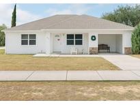 Charming single-story home featuring a covered porch and well-maintained front yard at 860 S Grove St, Eustis, FL 32726