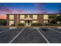 Brick building exterior with parking lot and landscaping at 1920 E Edgewood Dr # A4, Lakeland, FL 33803