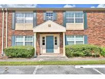 Brick building exterior with landscaping and parking at 1920 E Edgewood Dr # A4, Lakeland, FL 33803