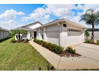 Single-story house with attached garage, landscaping, and walkway at 2178 Sunstone Dr, Lakeland, FL 33813