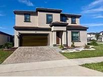 Two-story house with a large driveway and landscaped lawn at 187 Brooke'S Pl, Haines City, FL 33844