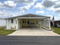 Charming one-story home featuring a carport and well-maintained landscaping, exuding curb appeal at 2055 S Floral Ave # 160, Bartow, FL 33830