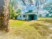 Charming one-story home with covered front porch and large front yard at 2496 Brooke Rd, Fort Meade, FL 33841