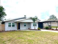 Charming single-story home featuring a well-maintained lawn and a covered carport at 3445 Avenue F Nw, Winter Haven, FL 33880