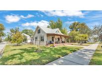 Charming two-story home with a covered front porch and a well-manicured lawn at 520 E Stanford St, Bartow, FL 33830