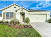 Charming single-story home features a well-manicured lawn and a two-car garage at 1835 Jackson Oaks Dr, Bartow, FL 33830