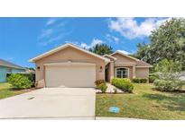 Charming one-story home with a two-car garage and well-maintained landscaping in a suburban neighborhood at 1850 Saddlewood Pl, Bartow, FL 33830