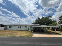 Charming single-story home with a covered carport and well-maintained lawn at 2055 S Floral Ave # 262, Bartow, FL 33830