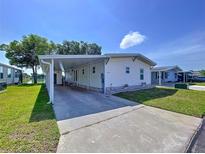 Well-maintained single-story home featuring a carport and landscaped front yard on a sunny day at 2055 S Floral Ave # 291, Bartow, FL 33830