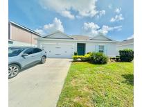Charming single-Gathering home with a two-car garage and well-maintained lawn at 264 Fiddlewood Ct, Davenport, FL 33837