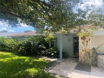 Charming single-story home with lush landscaping and inviting front entrance, creating a warm and welcoming curb appeal at 2742 Pine Acres Dr, Lake Wales, FL 33898