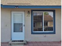 Inviting home featuring a front door, a window with blue trim, and the house number is prominently displayed at 294 Winter Ridge Blvd # 294, Winter Haven, FL 33881