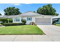 Charming single-story home boasts a well-manicured lawn and blue shutters at 3154 Prairie Dunes W Cir, Lakeland, FL 33810