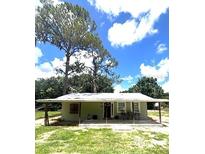 Charming single-story home with a covered porch, offering a cozy and inviting exterior at 4140 Old Dixie Hwy, Auburndale, FL 33823