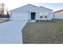 New single-story home with attached garage and landscaped front yard at 12966 Se 53Rd Ave, Belleview, FL 34420