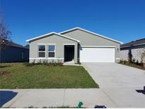 Charming single-story home with a well-maintained lawn and a two-car garage at 2408 Nw 22Nd Ct, Ocala, FL 34475